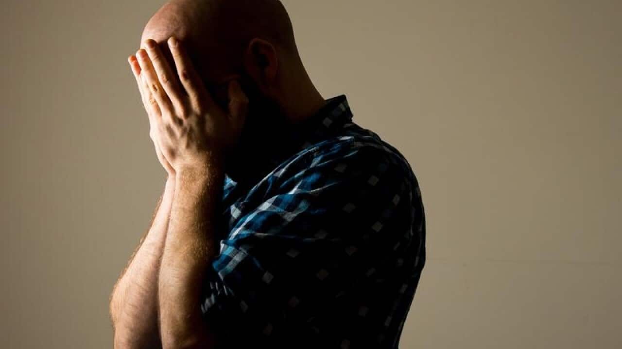 A man with his head in his hands