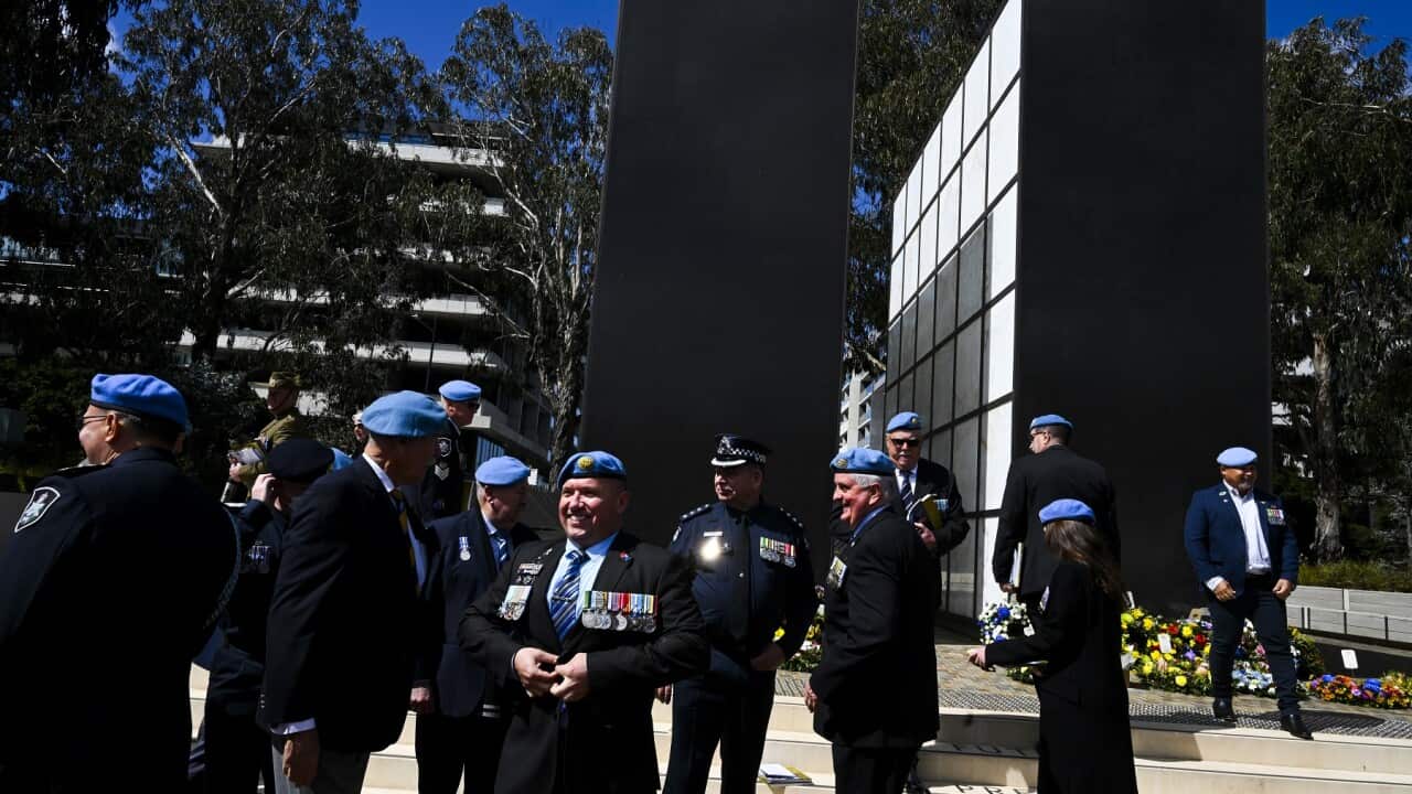 Former Australian peacekeepers pose for photographs after the commemorative service
