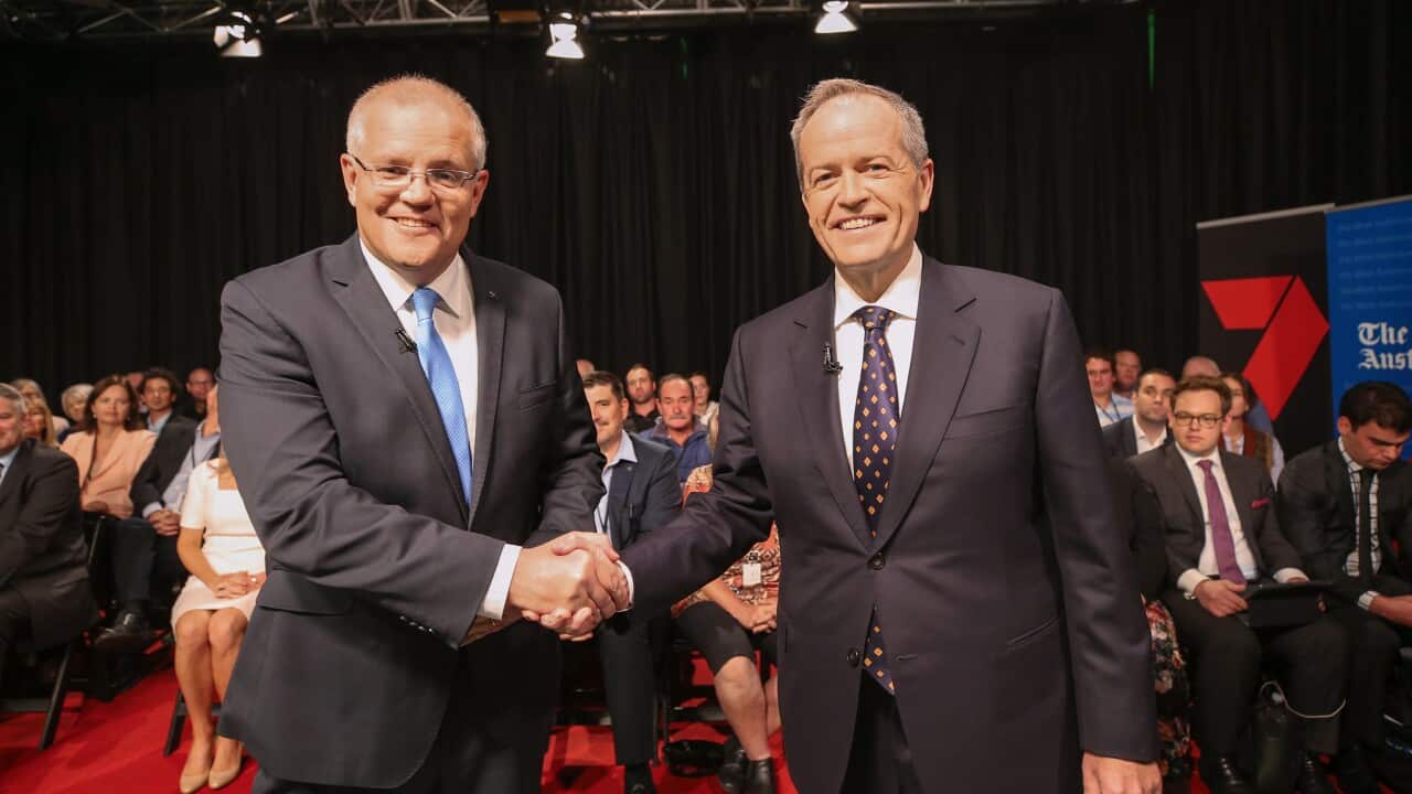 Prime Minister Scott Morrison and Opposition Leader Bill Shorten shake hands before the first leaders debate in Perth. 