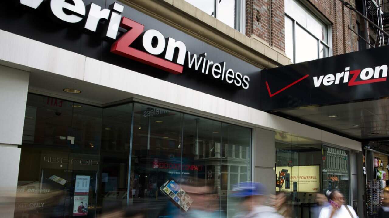 Pedestrians pass a Verizon Wireless store on in New York