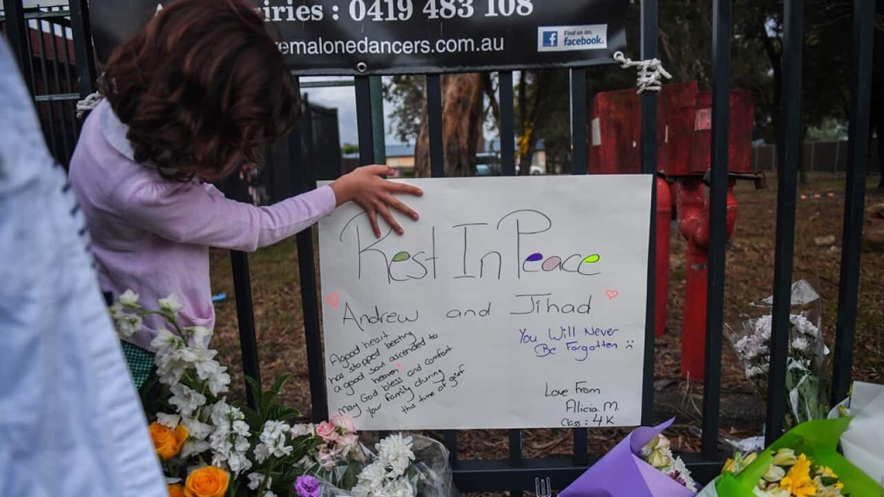 Members of the community attend a vigil outside Banksia Road Public School, Greenacre, Sydney
