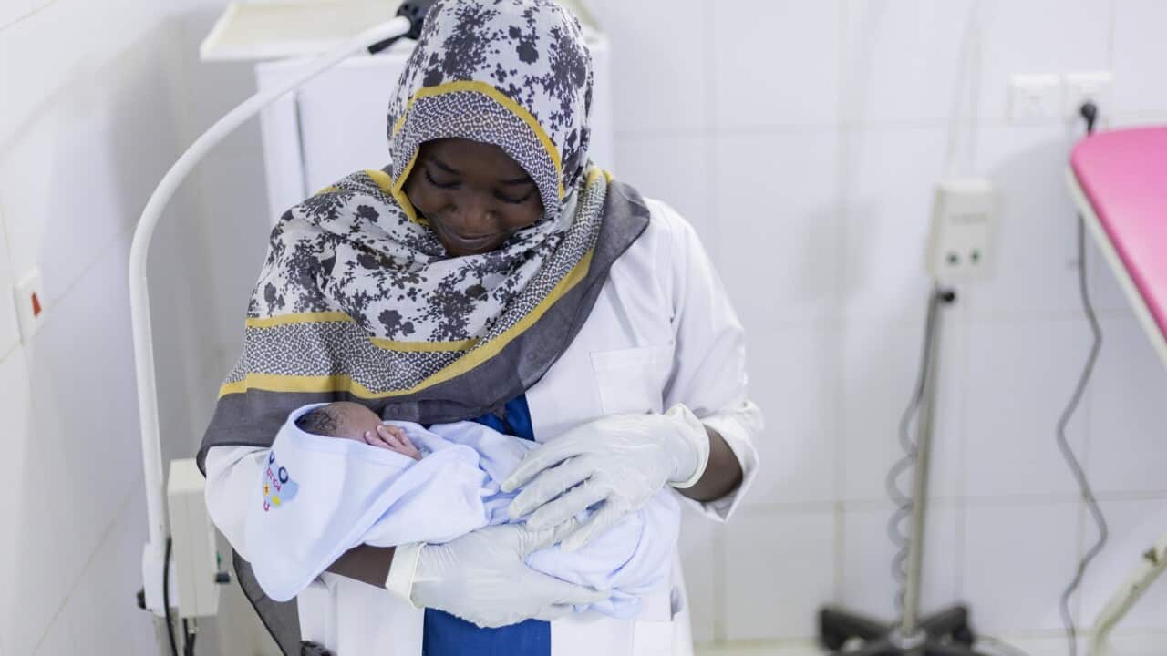 Namareq, a trained midwife attends to a newborn baby at Port Sudan Hospital.