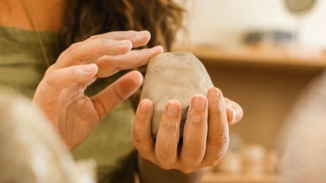 Le mani di Elena Carletti durante la lavorazione di un pezzo di argilla