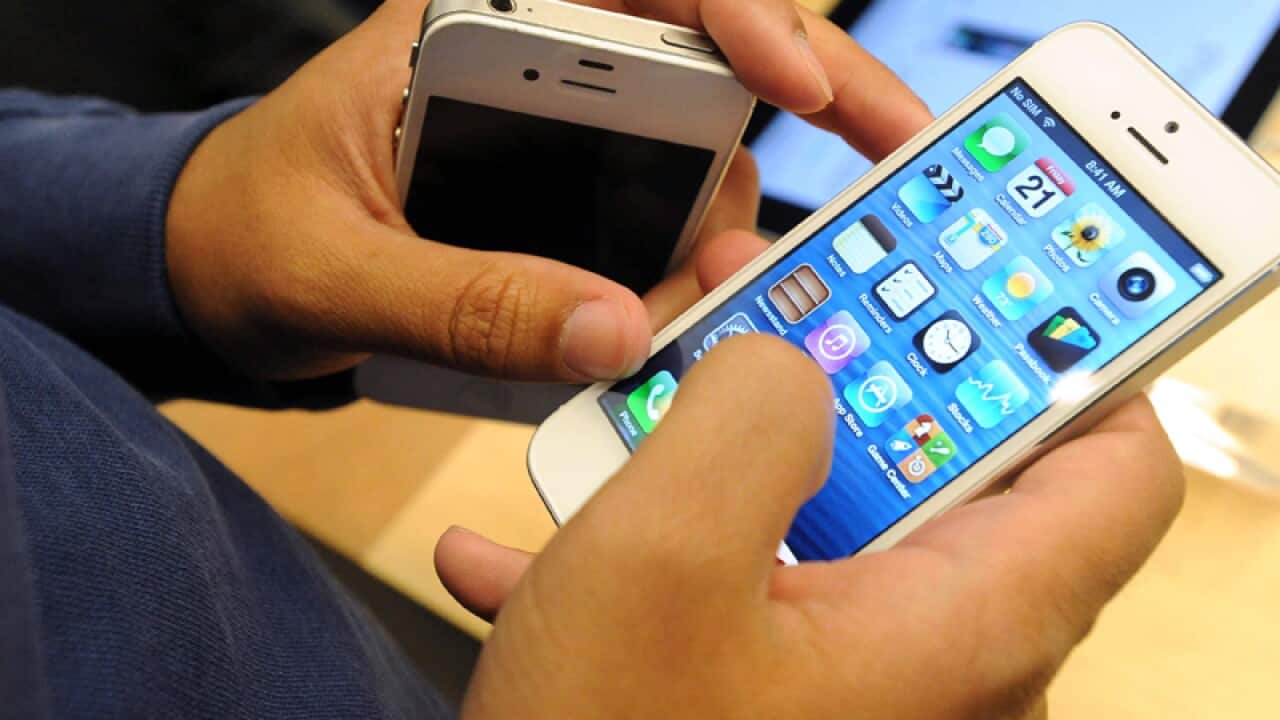 A customer takes a look at the new Apple iPhone 5