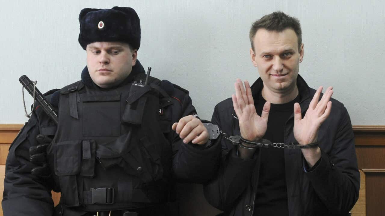 FILE - In this March 30, 2017 file photo, Russian opposition leader Alexei Navalny, right, poses for the press in court in Moscow, Russia. Imprisoned Russian opposition leader Alexei Navalny, President Vladimir Putin's main critic, was awarded the Europea
