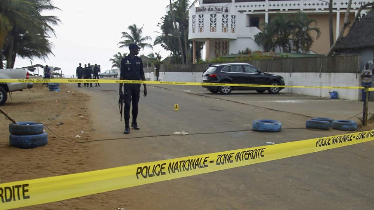 Ivorian police cordon off an area outside the Etoile du Sud hotel