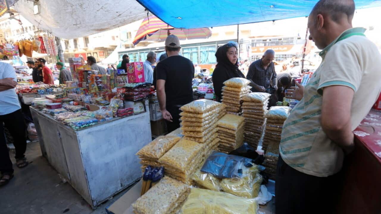 Iraqis shop for food as they prepare to fast the first day of Ramadan at a market in central Baghdad