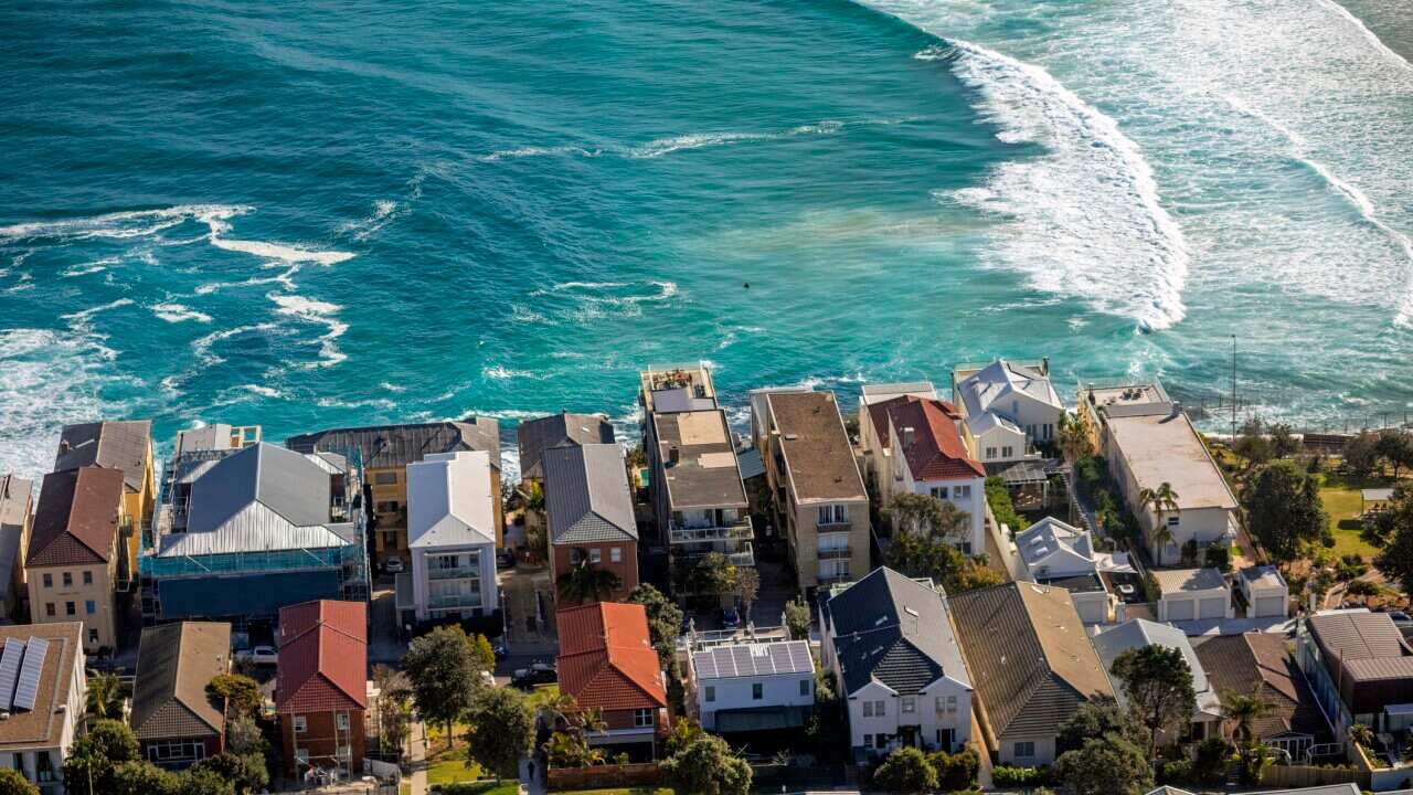 An overhead view of houses next to the ocean