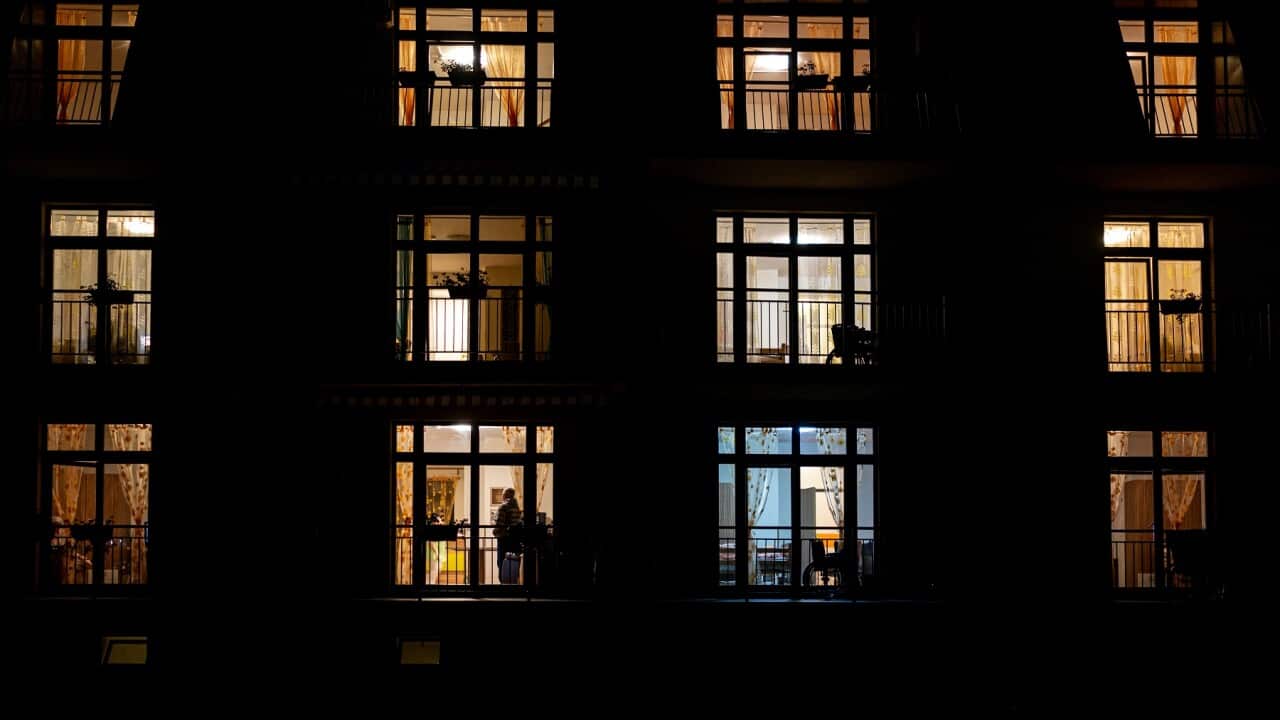 Illuminated windows of night house with people inside.jpg