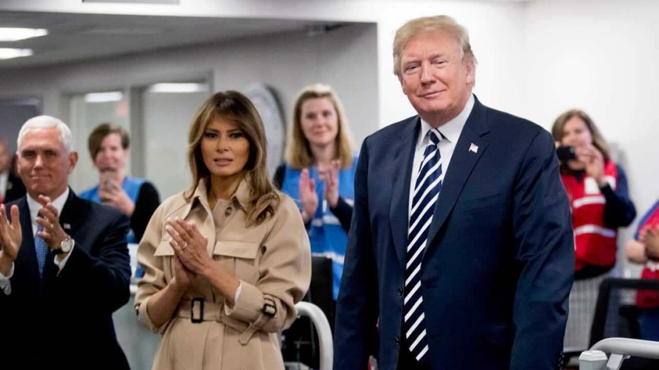President Donald Trump, center, accompanied by Vice President Mike Pence, left, and first lady Melania Trump, second from left