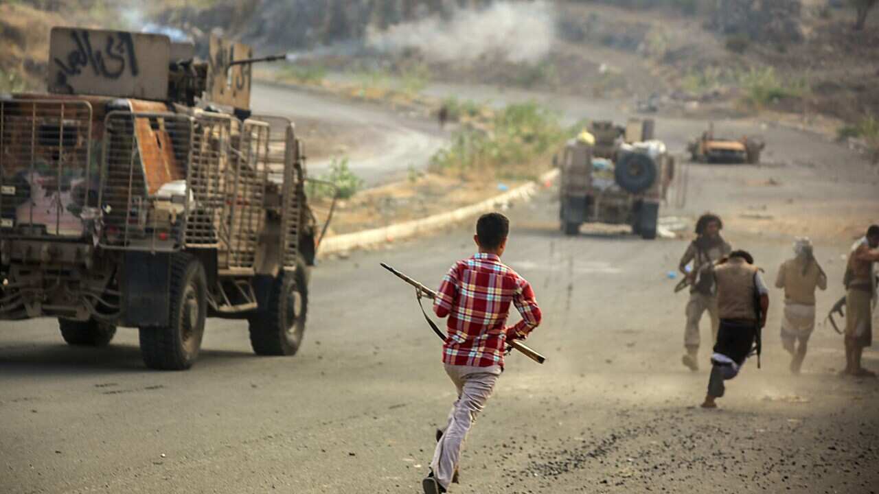 boy with gun, running, road, trucks