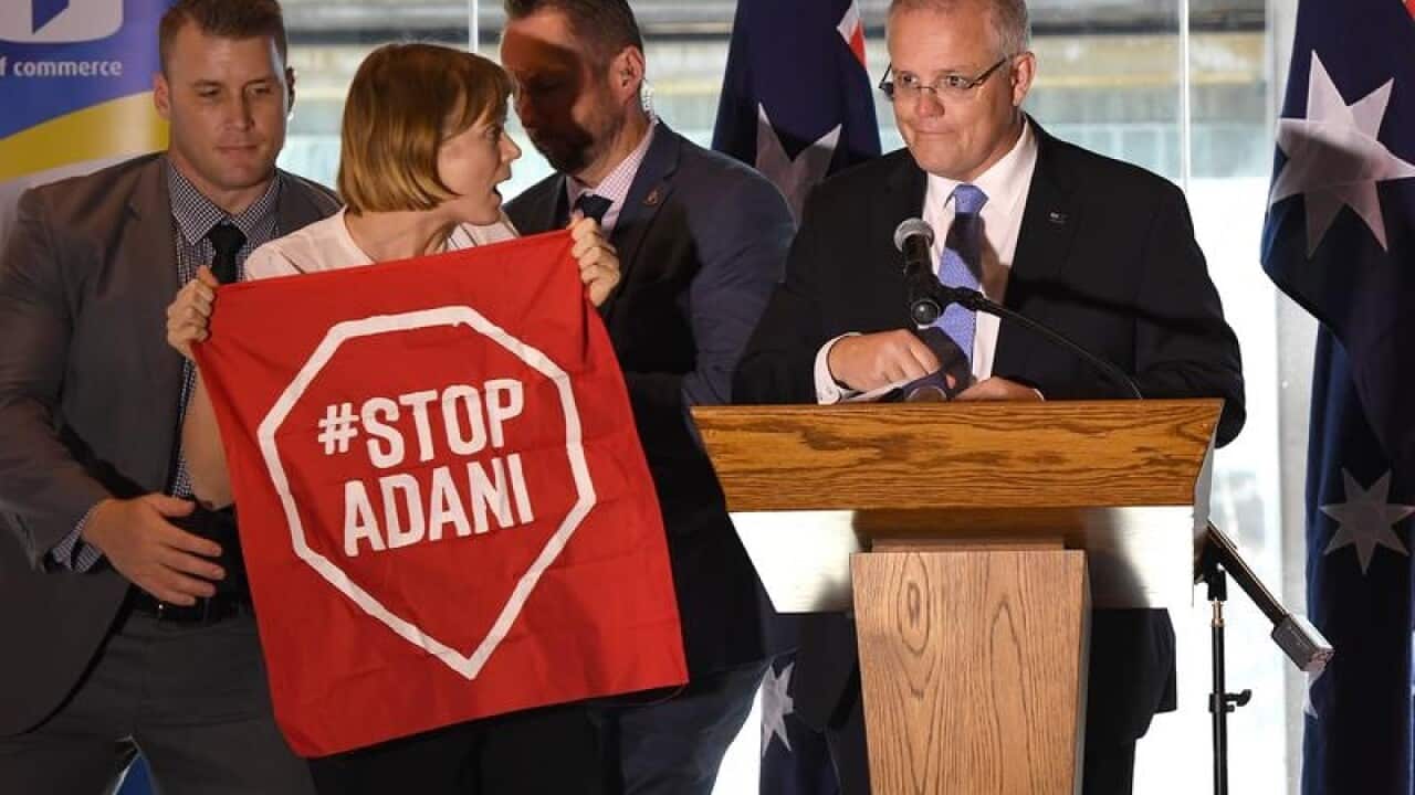 A Stop Adani protestor confronts PM Scott Morrison.