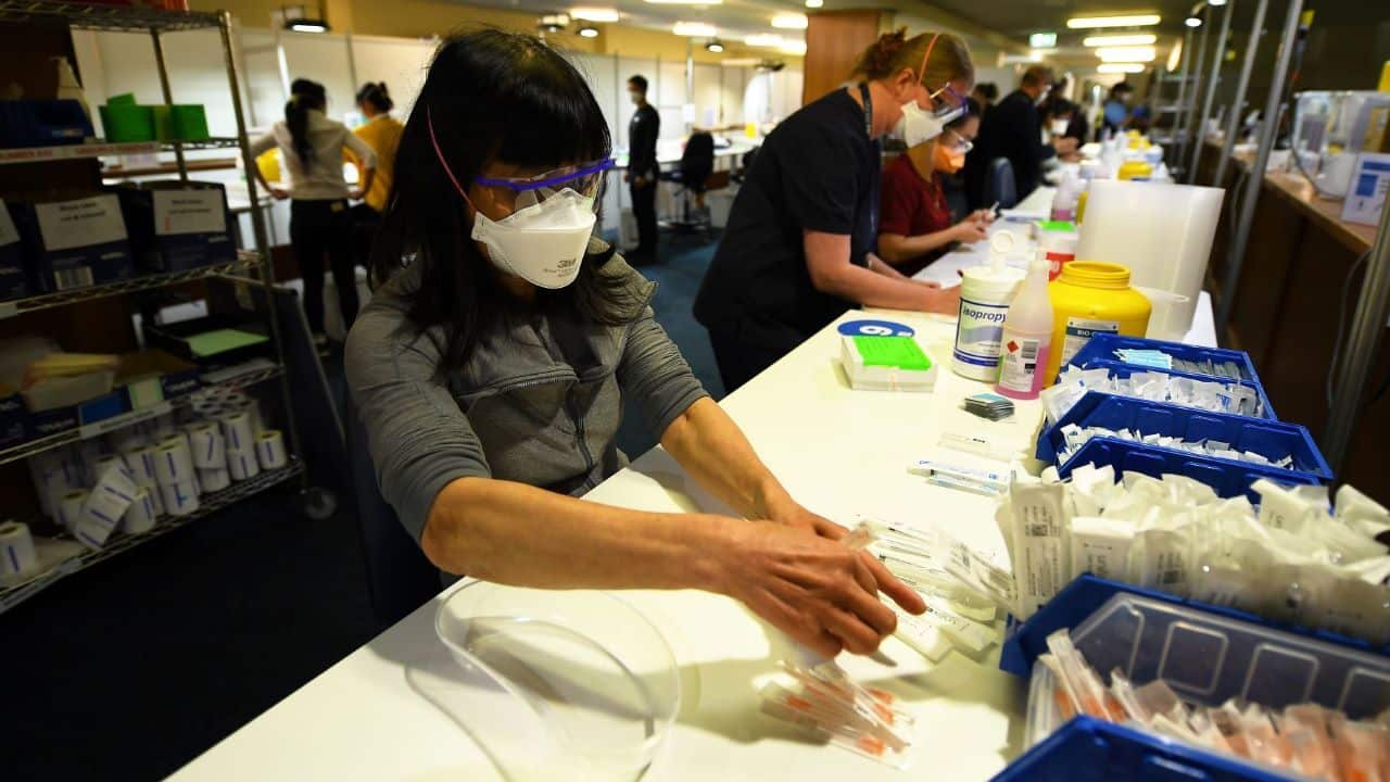 Healthcare workers are seen prepping Covid19 vaccinations at the vaccination centre at Sandown Racecourse in Melbourne
