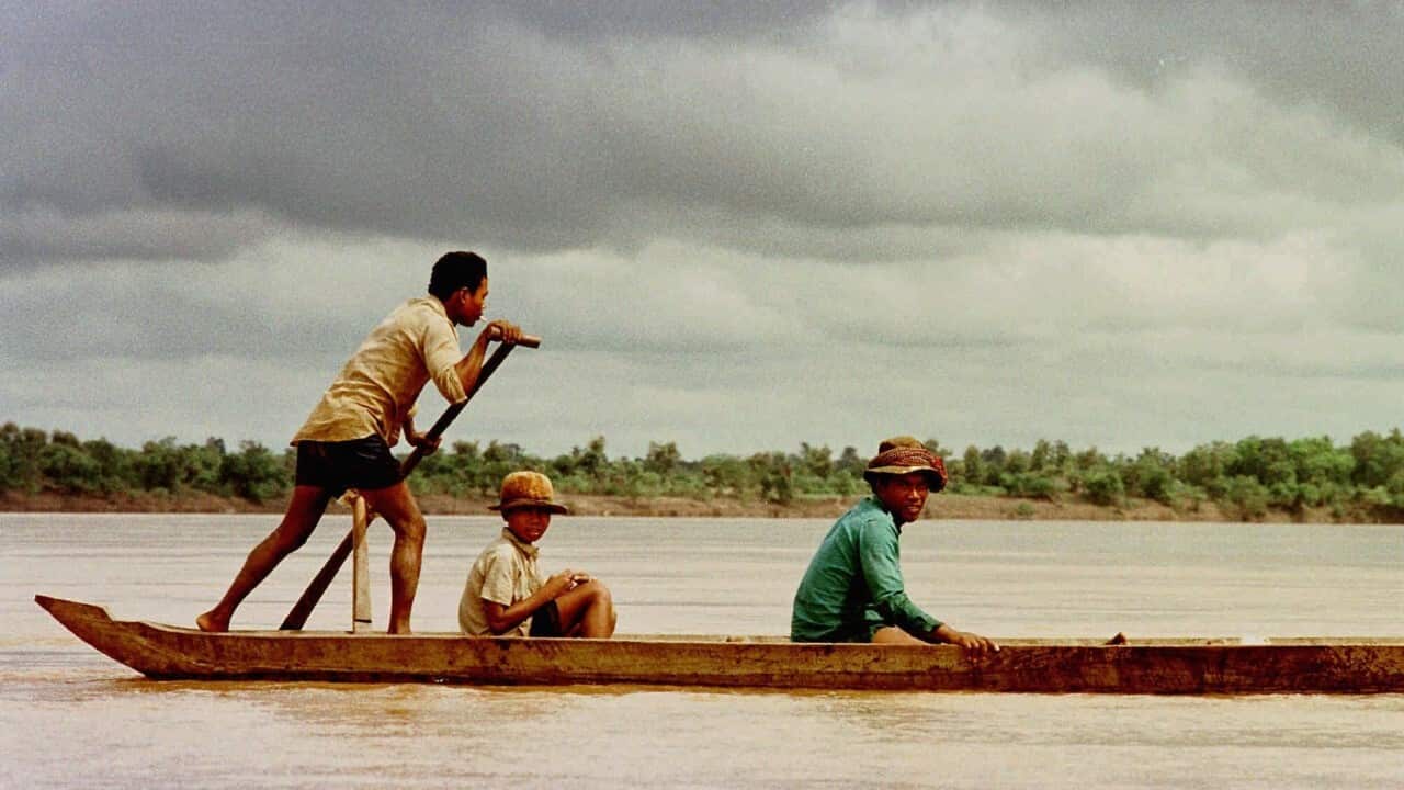 Villagers ride a dugout up the Mekong (AAP Image - AP Photo - Richard Vogel)