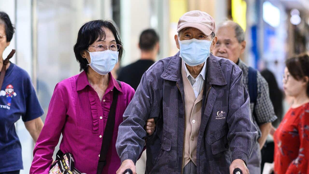 A couple wearing face masks in Sydney