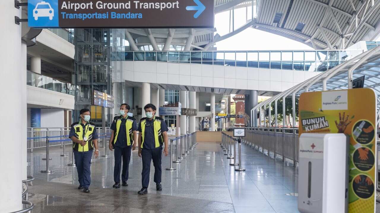 Workers at the international arrivals area during the opening of Ngurah Rai International airport in Bali