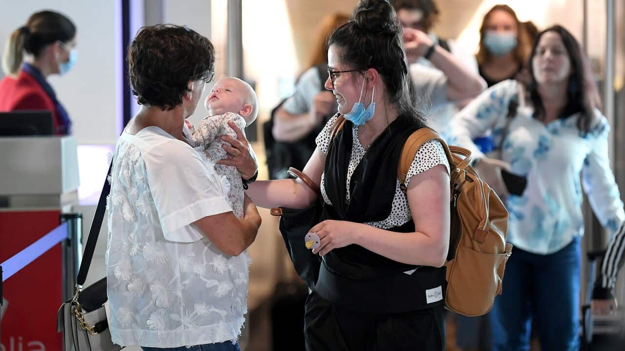 Passengers are reunited with loved-ones after arriving on the first flight from Melbourne at the Brisbane Domestic Airport in Brisbane, Tuesday, December 1, 2020.