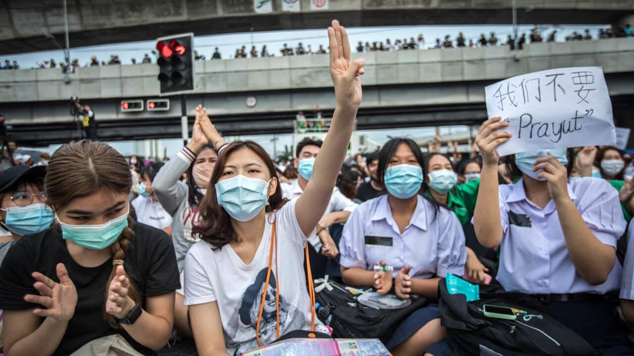 A pro-democracy protester seen making the three finger salute during an anti-government demonstration in the Thai capital.