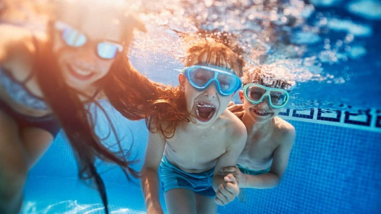 Happy kids playing underwater