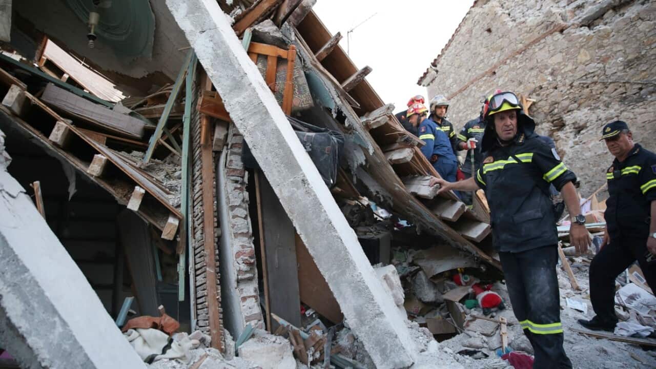 Fire department rescue team search for survivors, trapped in a collapsed house in the village of Vrissas