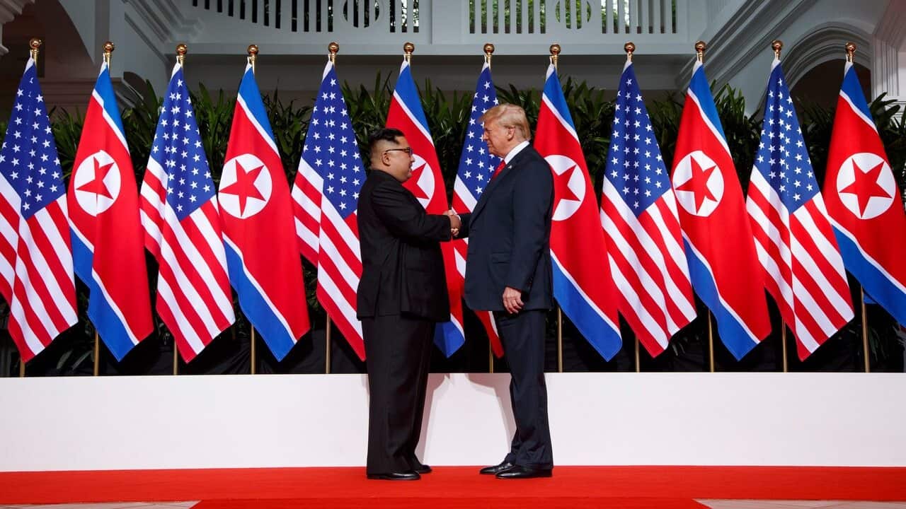 US President Donald Trump shakes hands as he meets with North Korean leader Kim Jong Un on Sentosa Island, in Singapore.