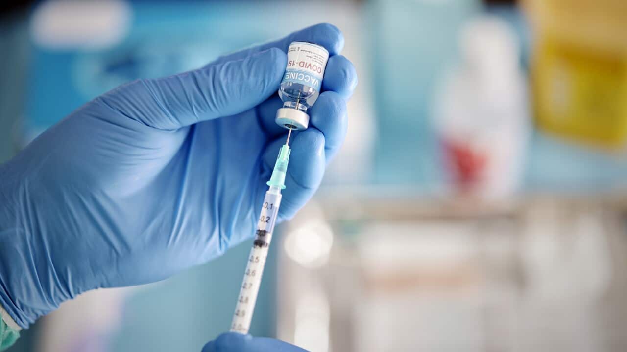A Healthcare Worker Prepares a Dose of COVID-19 Vaccine.