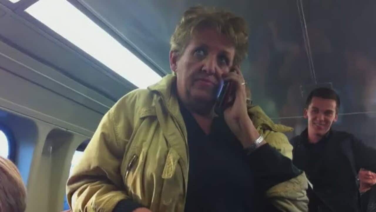 The woman who was filmed racially abusing an Asian woman on a Sydney train has, in turn, copped a tirade of online abuse. (Screenshot:YouTube)
