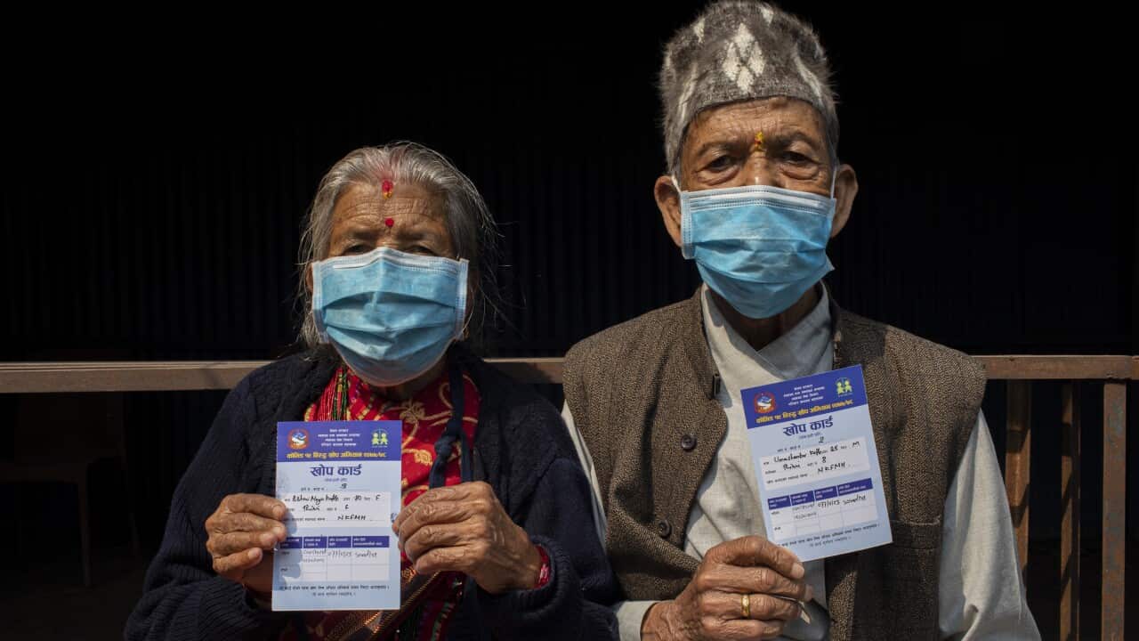 An elderly couple shows their Vaccine Cards after receiving a dose of Covishield COVID-19 vaccine at Korean Hospital in Bhaktapur, Nepal, 07 March 2021.