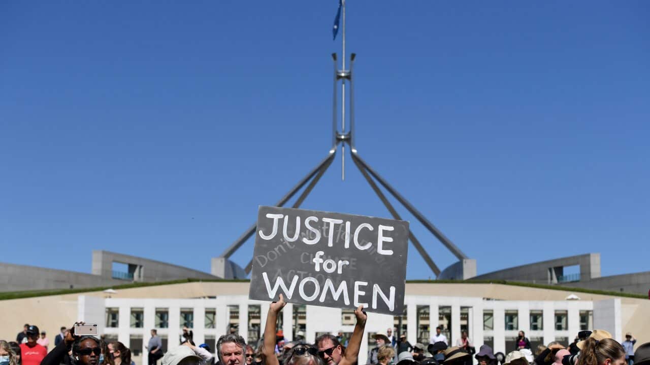 A protesters holds a placard during the Women's March 4 Justice in Canberra on Monday.