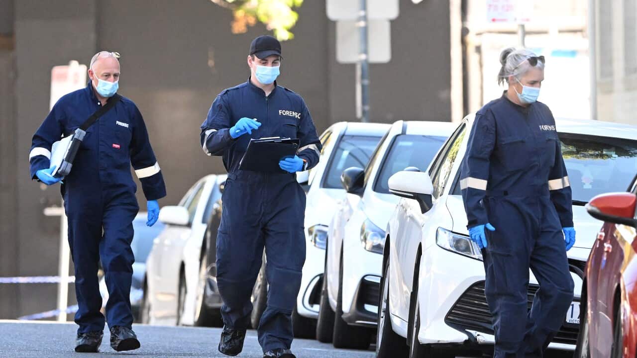 Three police officers at a crime scene.