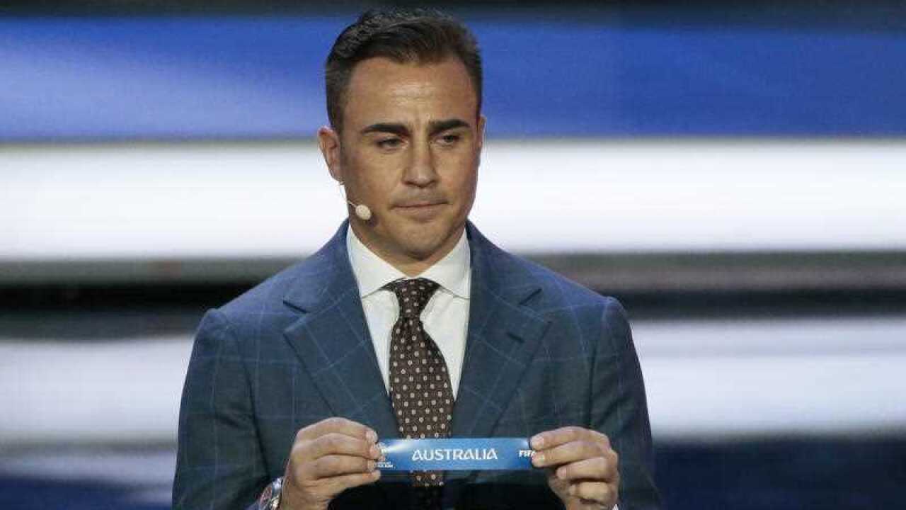Fabio Cannavaro holds up the team name of Australia at the 2018 soccer World Cup draw
