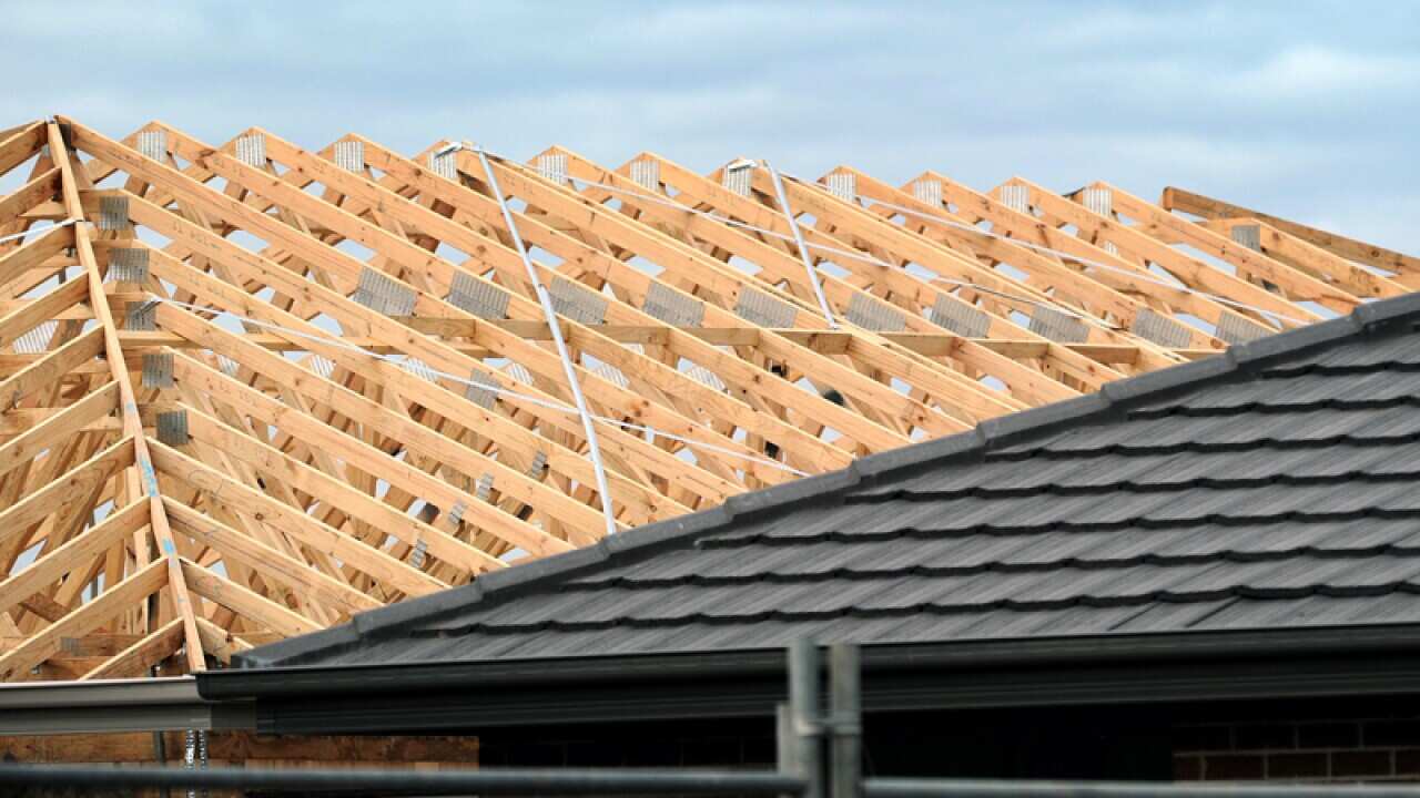 Builders work on homes at a new estate on the outskirts of Geelong
