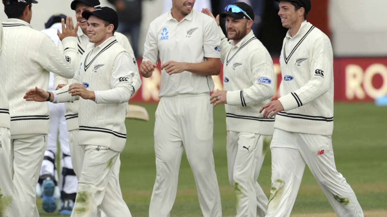 Tim Southee (C) is celebrated by his captain Brendon McCullum