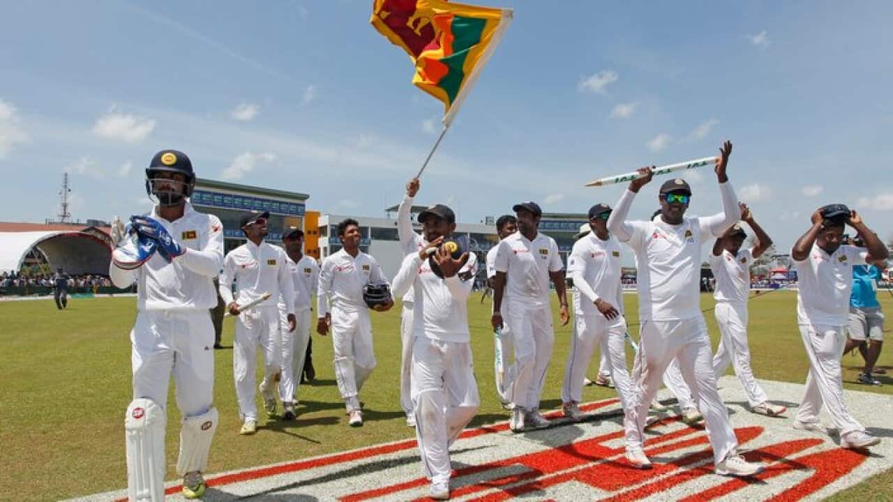 Sri Lanka's team members acknowledge the crowd as they celebrate their victory over Australia by 229 runs in the second test cricket match in Galle, Sri Lanka, Saturday, Aug. 6, 2016. (AP Photo/Eranga Jayawardena)