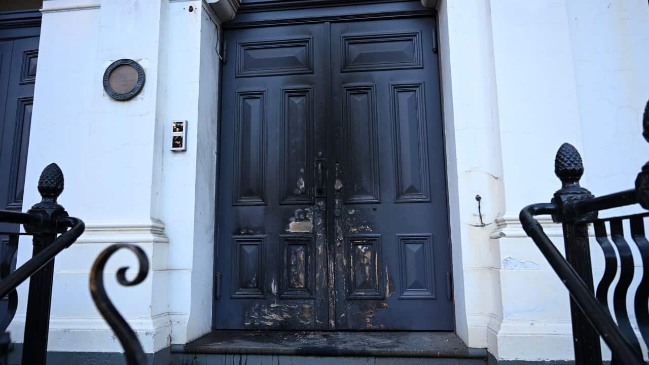 A door to a synagogue that has been damaged by a fire.