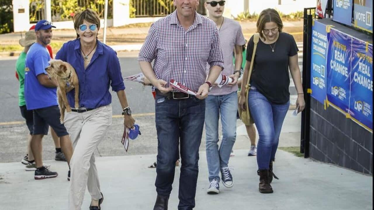 LNP member Scott Emerson arrives to vote with his family.