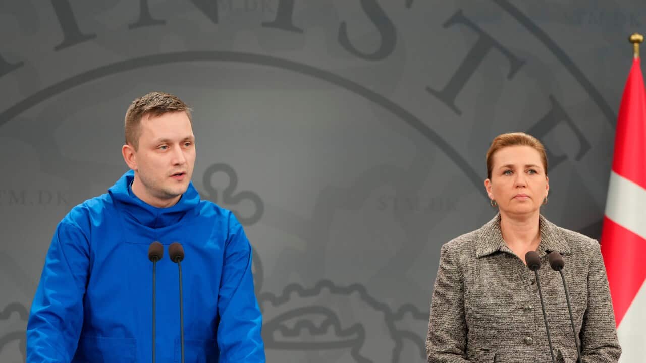 Jens-Frederik Nielsen and Mette Frederiksen stand together during press conference.
