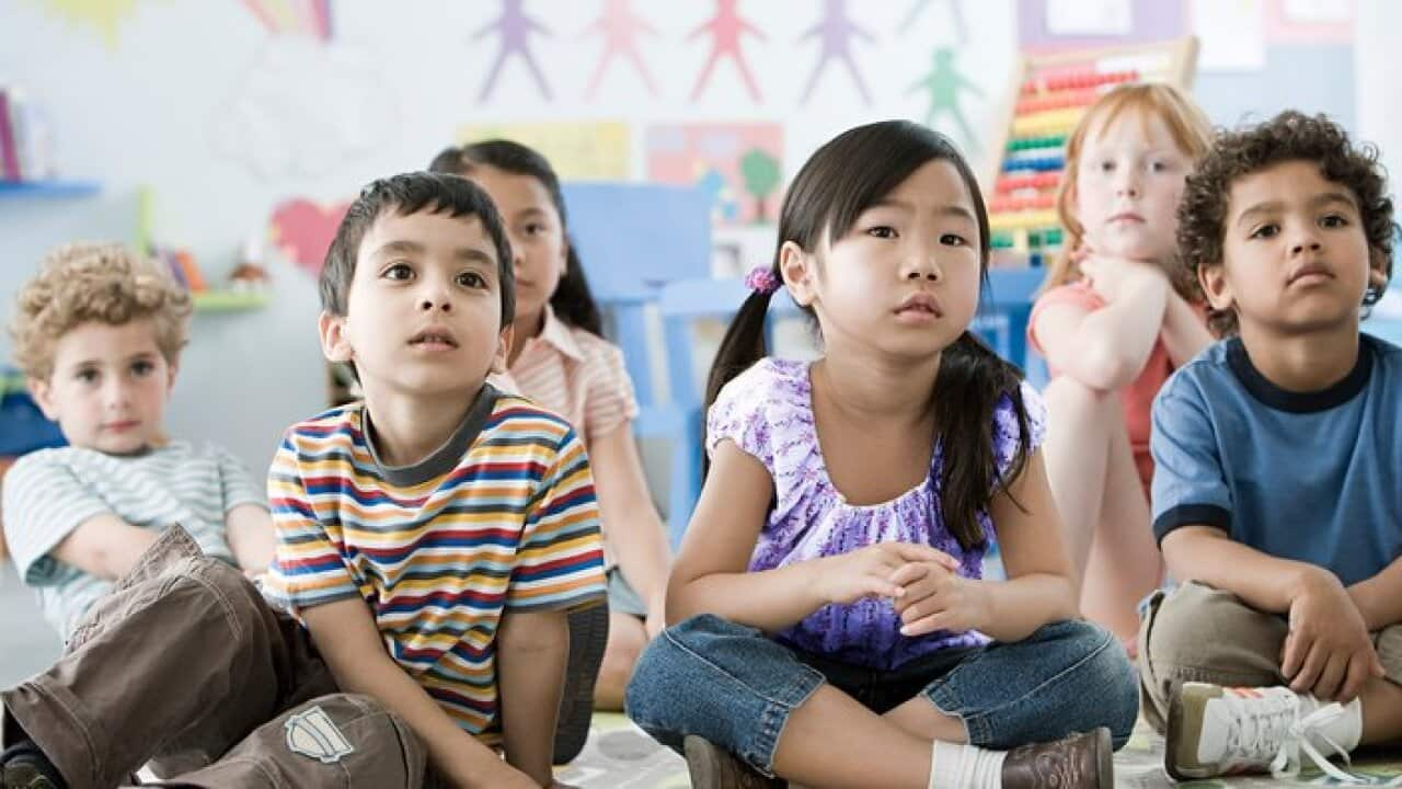 Children sitting on a floor