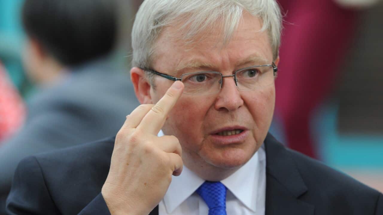 Prime Minister Kevin Rudd adjusts is glasses