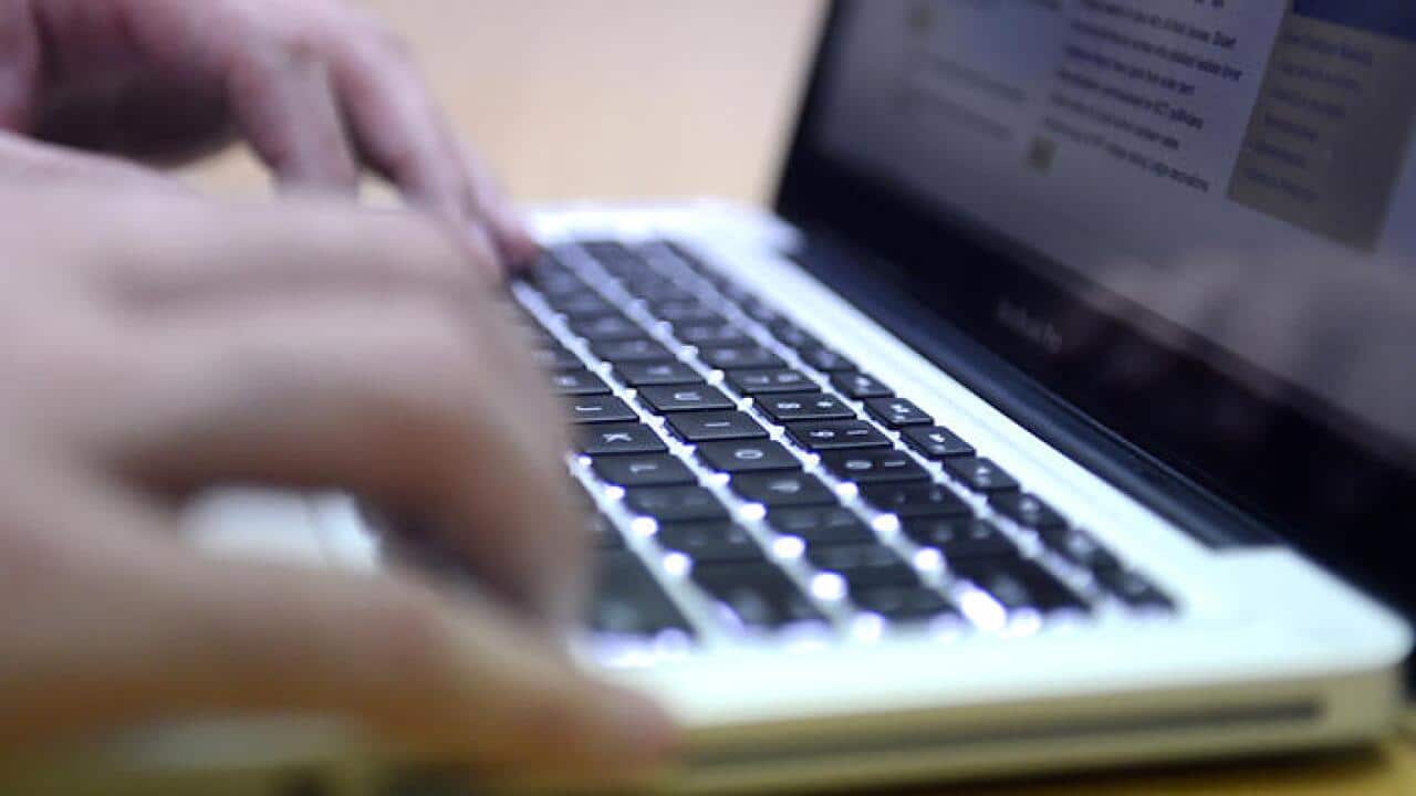 A man uses a laptop computer in Brisbane Monday, Sept. 16, 2013. (AAP Image/Dan Peled) NO ARCHIVING