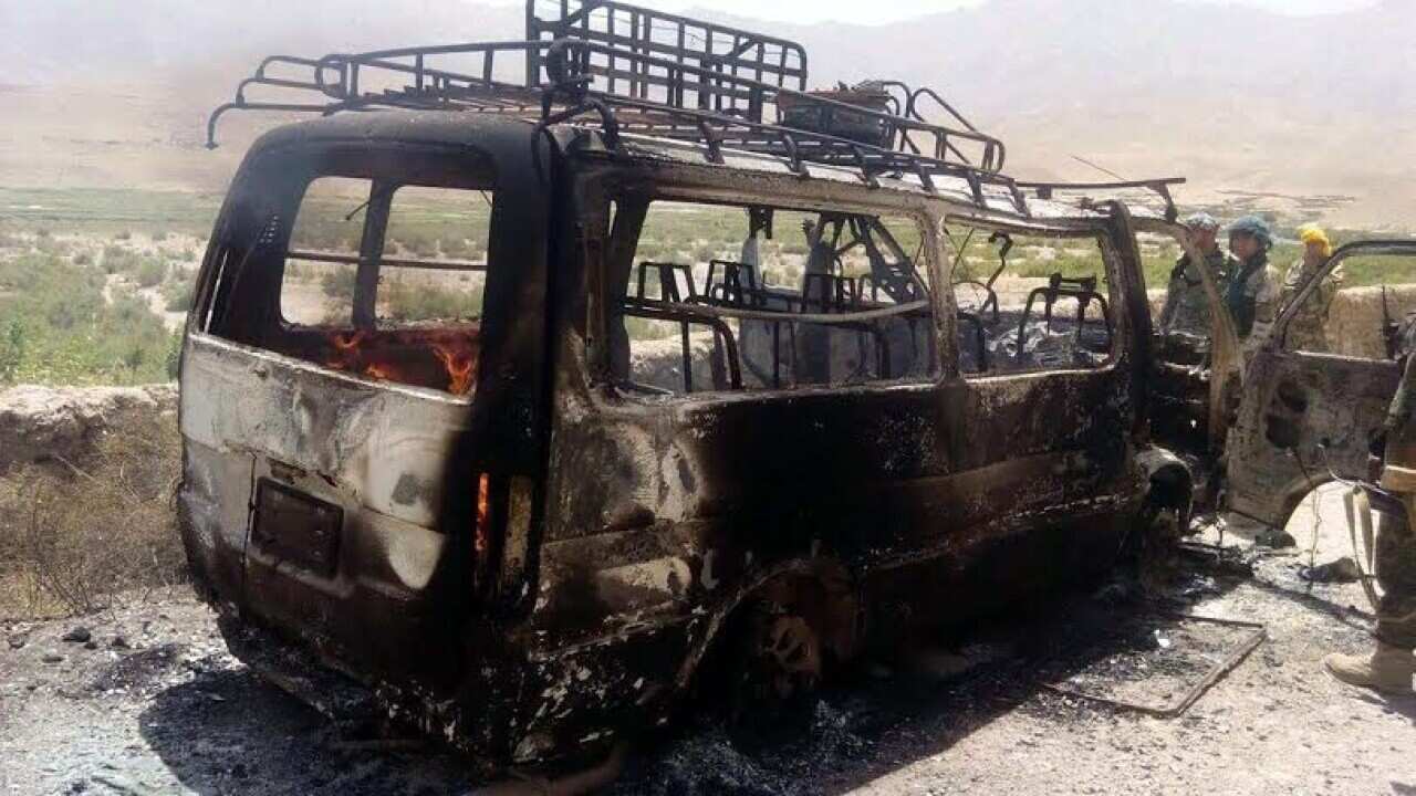 Afghan security officials inspect a van that was believed to have been transporting foreign tourists in Chesht-e-Sharif district of Herat province, Afghanistan