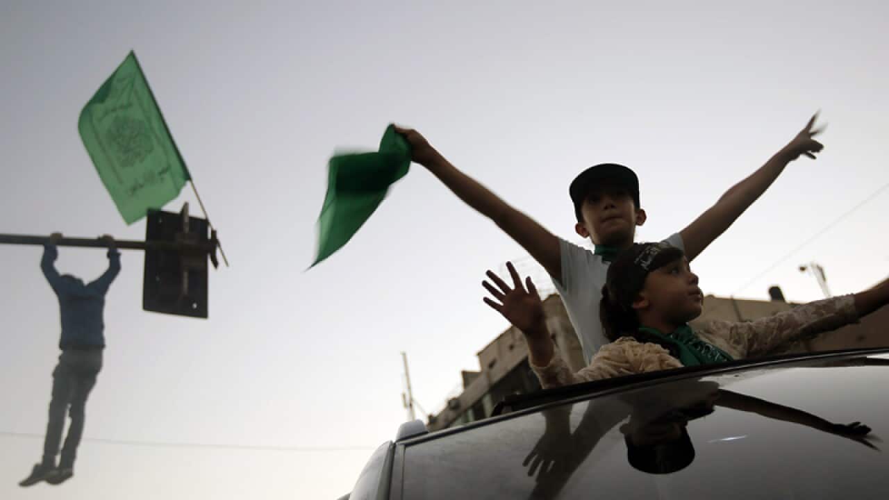 Young Palestinians celebrate a ceasefire in Gaza City