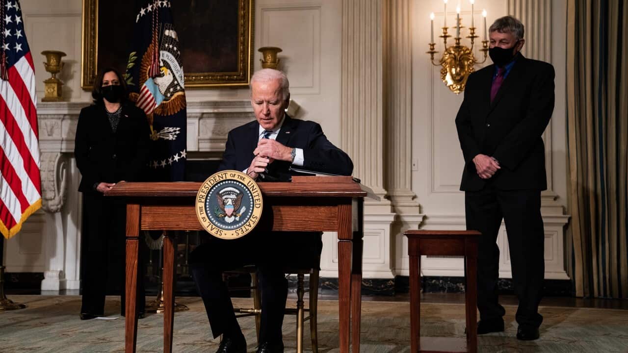 President Joe Biden signs an executive order regarding his administration's response to climate change