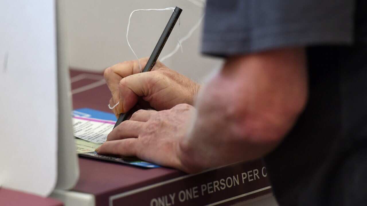 A voter makes his selection at a polling booth