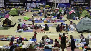 Thai evacuees who fled from their homes following clashes between Thai and Cambodian troops, rest at a gymnasium turned into an evacuation center in Si Sa Ket province, Thailand, 10 December 2025.