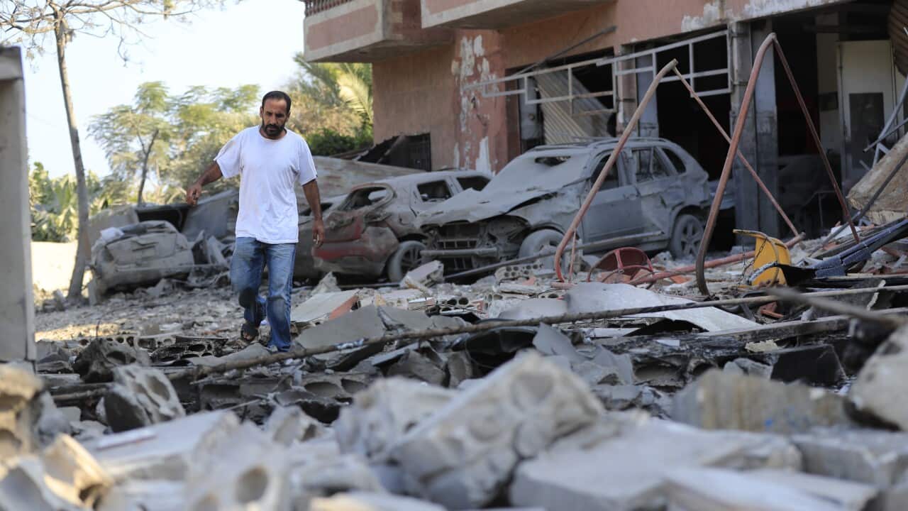 A man checks the damage to a building hit in an Israeli airstrike in the southern village of Akbieh, Lebanon,