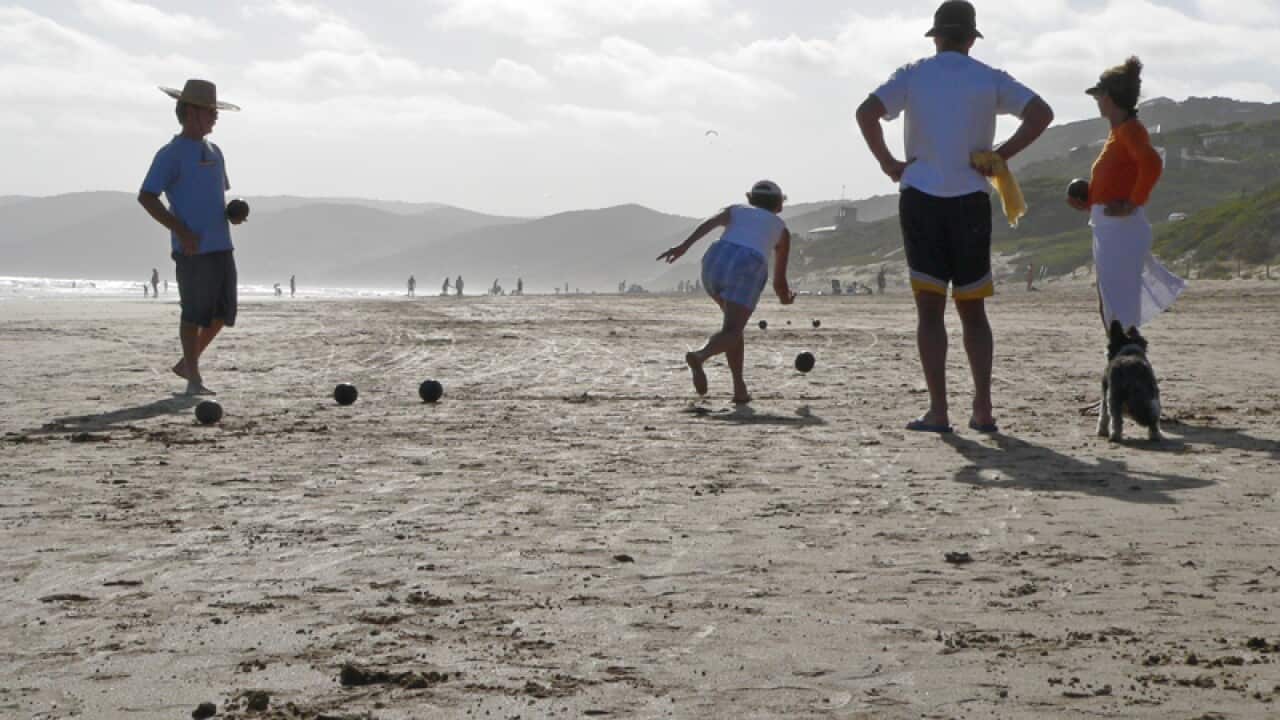 Beachgoers at Fairhaven Beach in Victoria