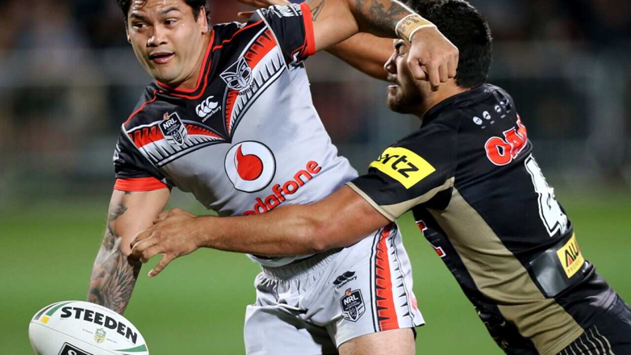 Issac Luke of the Warriors is tackled by Peta Hiku of the Panthers