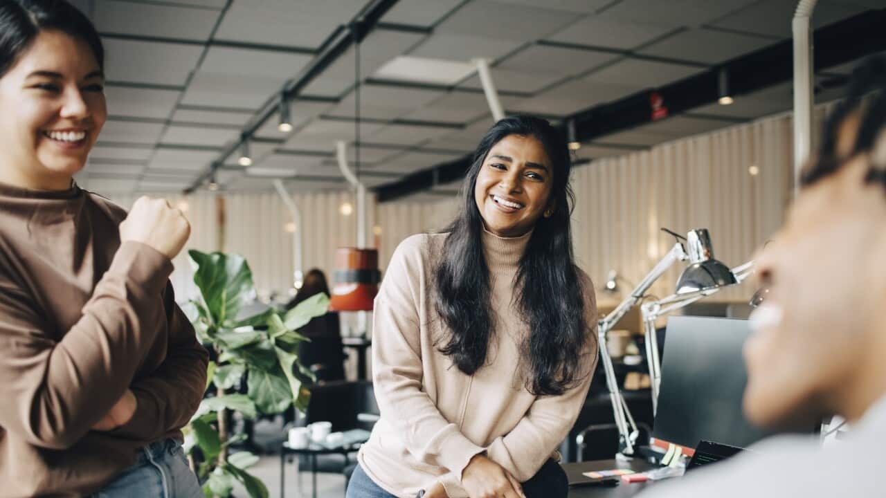 Happy female business professionals enjoying during team meeting at office