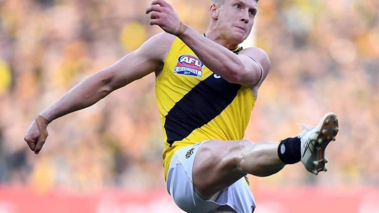 Josh Caddy of the Tigers is seen in action.
